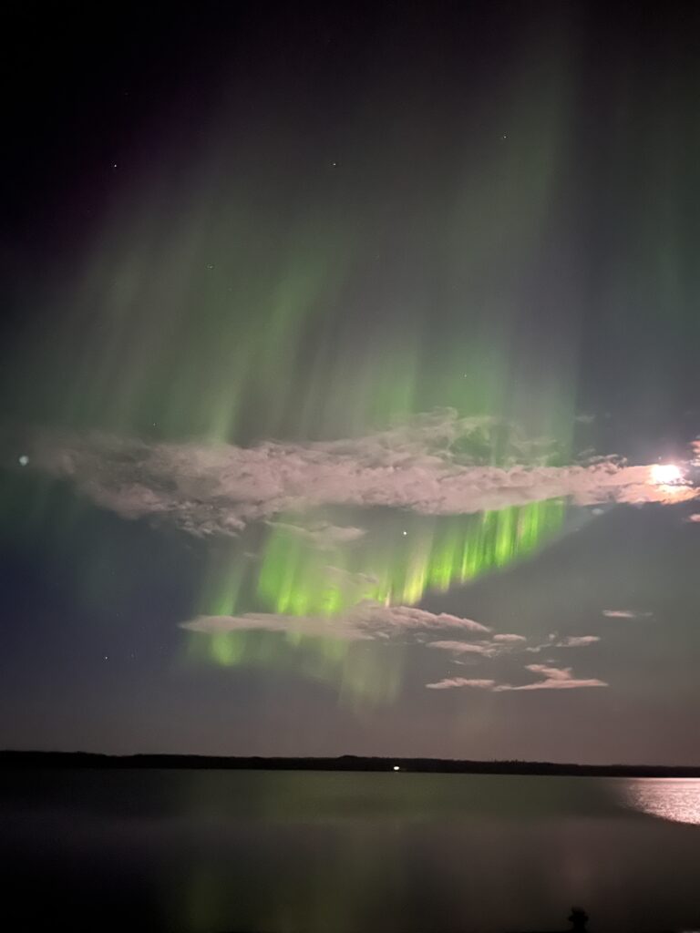 northern lights over still lake