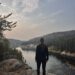 Woman standing at viewpoint during a hike at Cameron Falls, Yellowknife