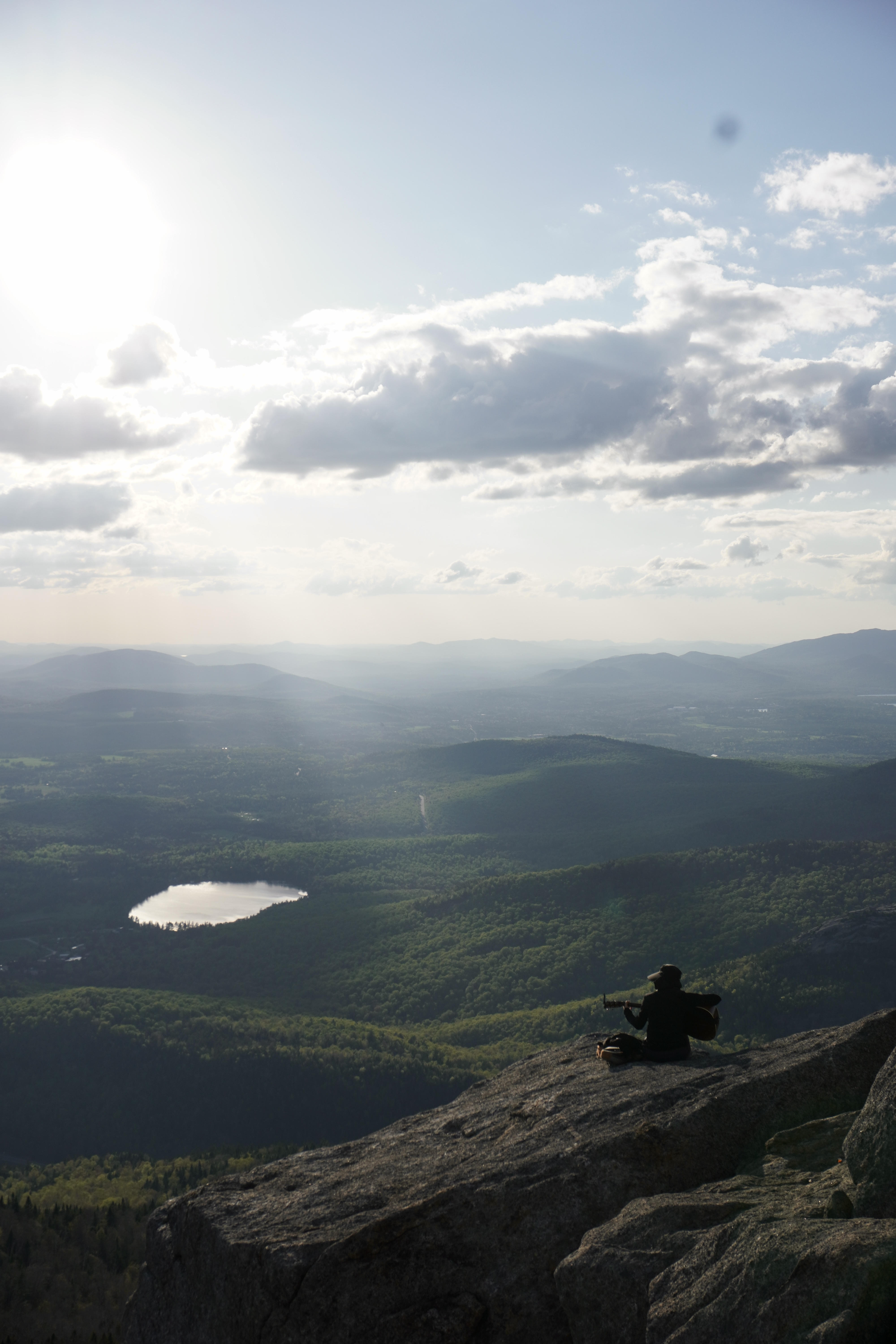 person singing on top cascade mountain with view